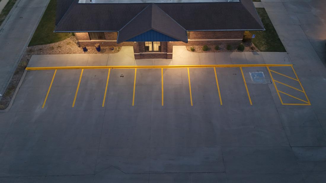 Fresh parking lot line striping and ADA markings at a commercial lot, central Kansas
