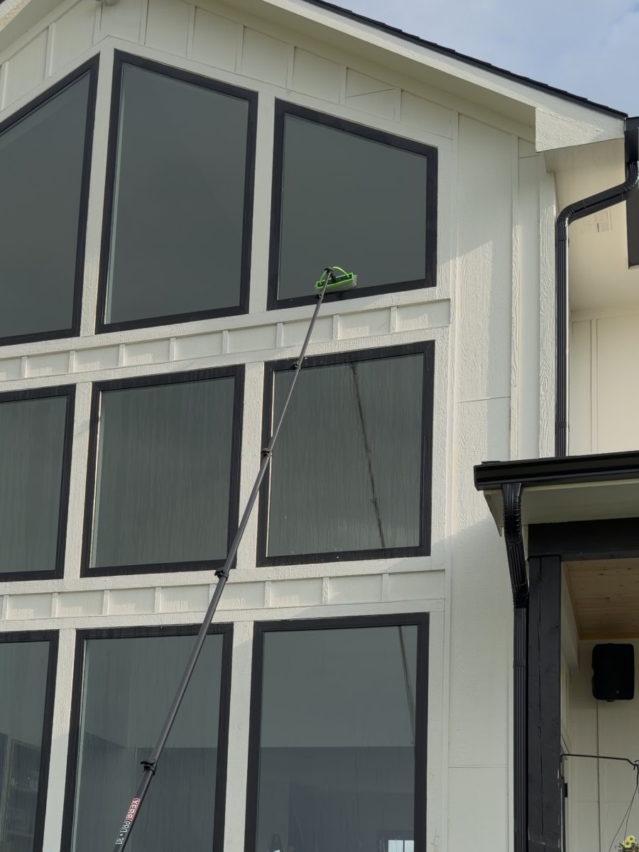 Water-fed pole cleaning second-story windows on a home in McPherson